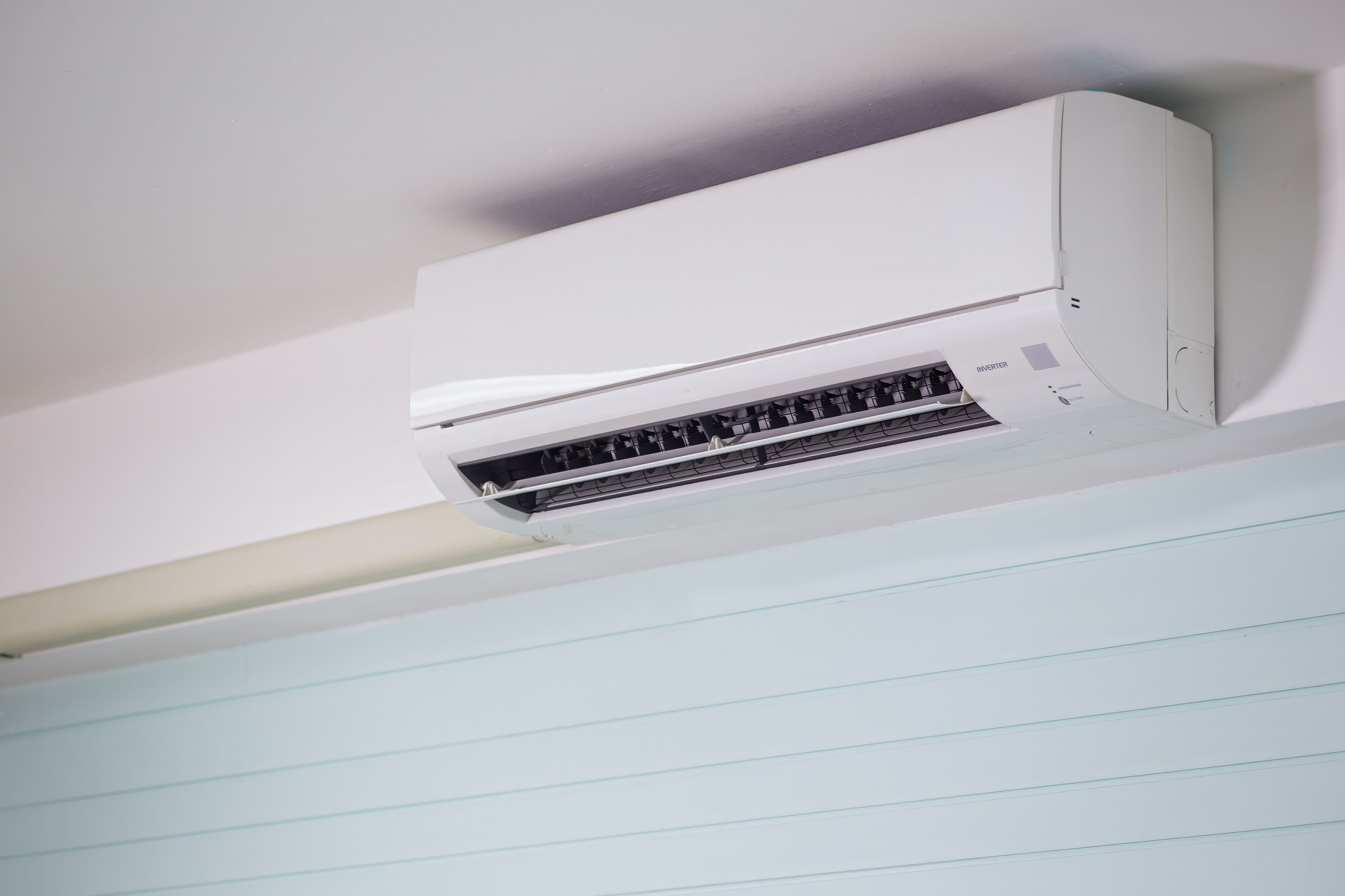 Wall-mounted air conditioning unit installed on a house in Calgary